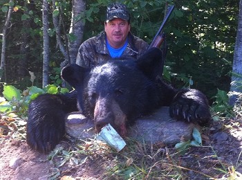 Hunters pose with black bear, Hunting at Ontario Hunting and FIshing Lodge