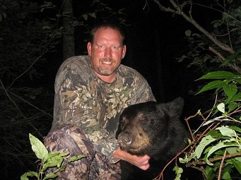 Night, posing next to black bear head