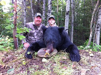 Posing with their trophy catch black bear